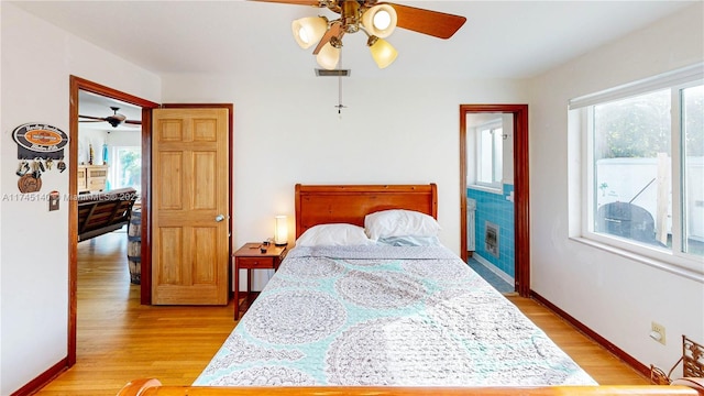 bedroom featuring ceiling fan, light wood finished floors, and baseboards