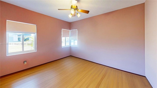 spare room with ceiling fan and wood finished floors