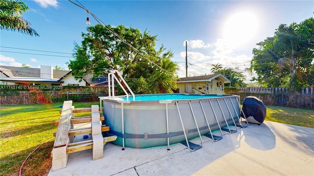 view of swimming pool with a patio area, a fenced in pool, fence, and a lawn