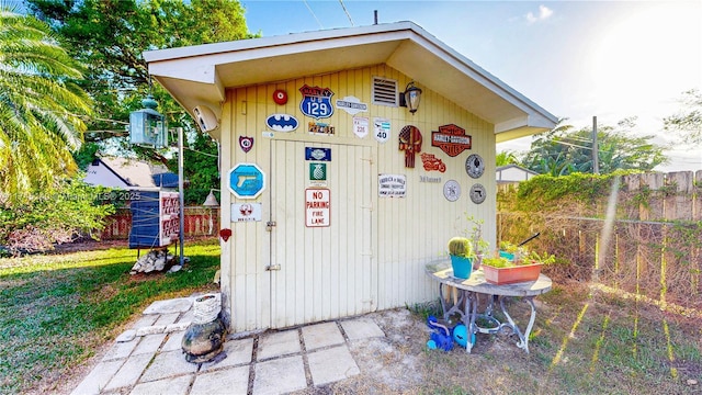 view of outbuilding with fence