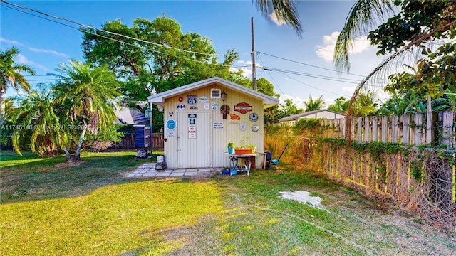 view of outdoor structure with an outbuilding and fence