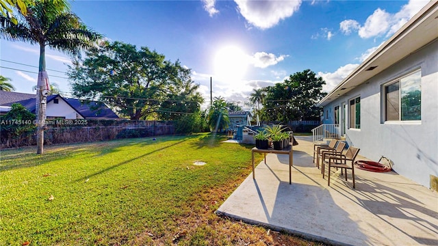 view of yard with a patio and fence