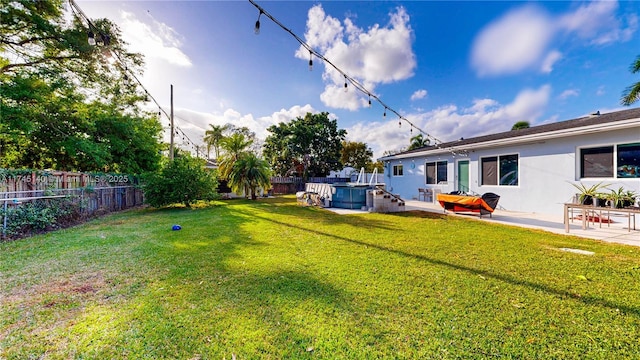 view of yard featuring a fenced backyard, a jacuzzi, and a patio