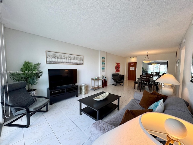 living room with marble finish floor and a textured ceiling
