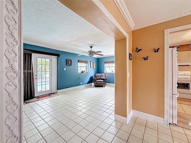 interior space featuring light tile patterned floors, plenty of natural light, a textured ceiling, and crown molding