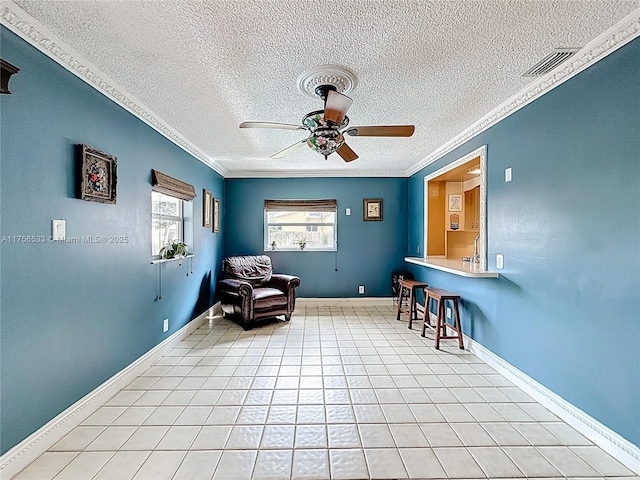 sitting room featuring visible vents, crown molding, baseboards, and light tile patterned floors