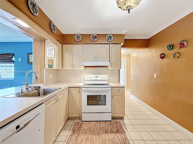 kitchen with white appliances, light countertops, crown molding, under cabinet range hood, and a sink