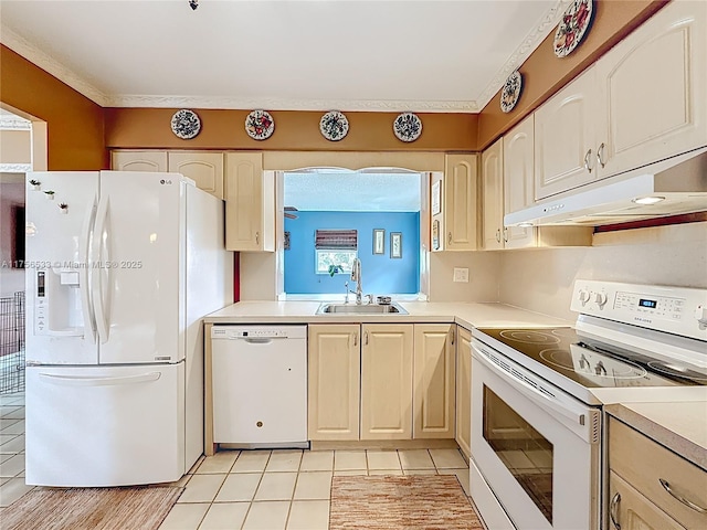 kitchen featuring light countertops, white appliances, a sink, and under cabinet range hood