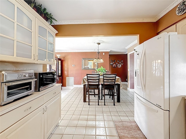 kitchen with visible vents, ornamental molding, glass insert cabinets, light tile patterned flooring, and white fridge with ice dispenser