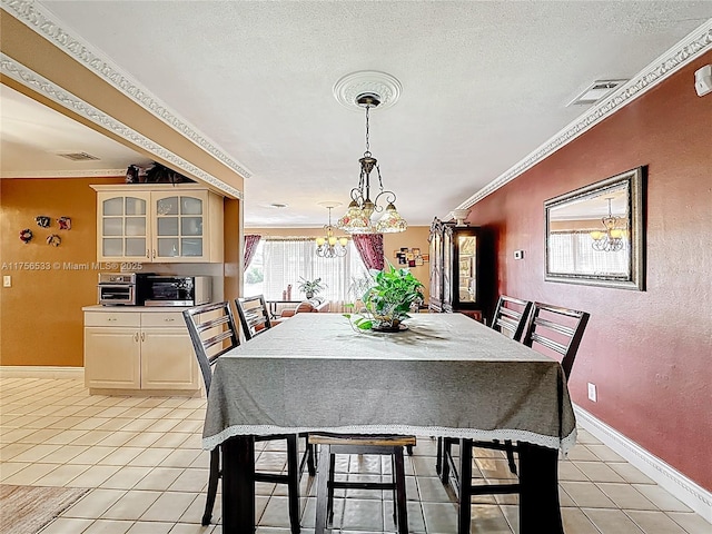 dining space with light tile patterned floors, a textured ceiling, visible vents, and crown molding