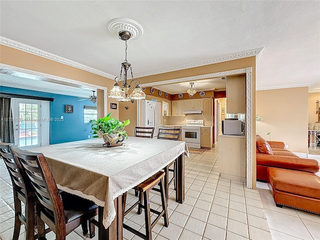 dining room featuring a textured ceiling, light tile patterned flooring, and crown molding