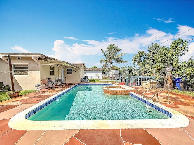 view of pool featuring a patio, fence, a fenced in pool, and an in ground hot tub