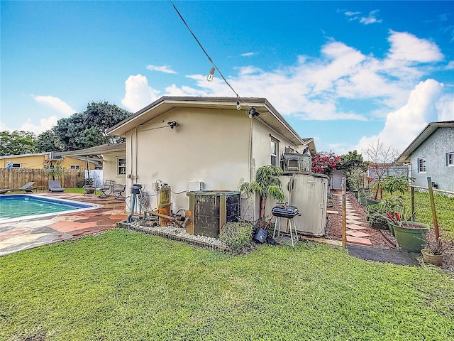 view of home's exterior with a patio, a fenced backyard, central AC, a yard, and stucco siding