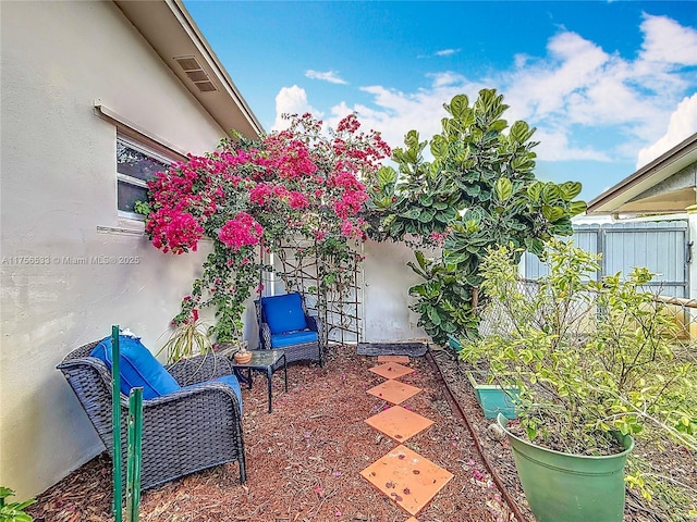 view of patio featuring fence and visible vents