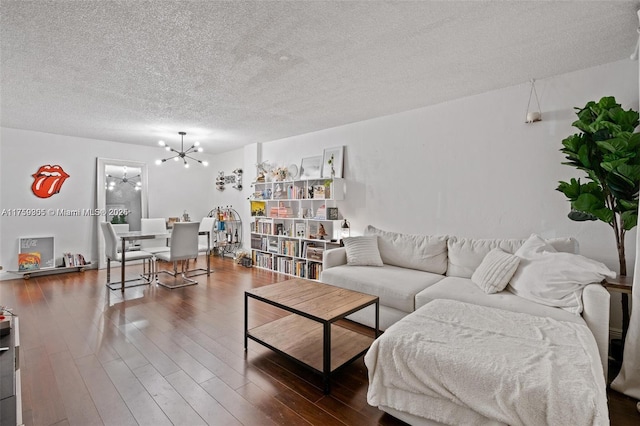 living area featuring a chandelier, a textured ceiling, and wood finished floors