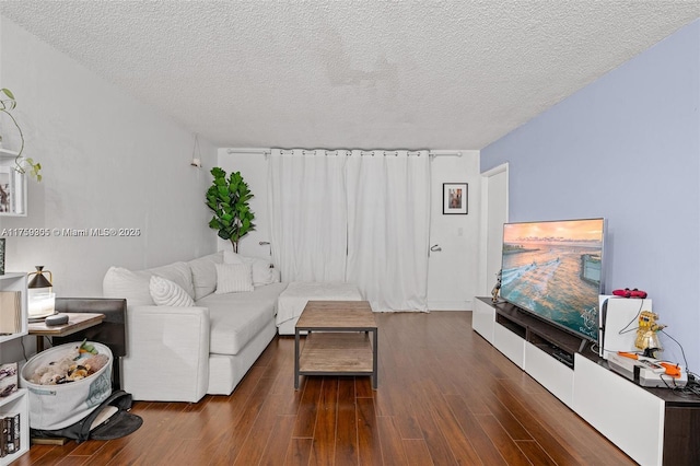 living room featuring a textured ceiling and wood finished floors