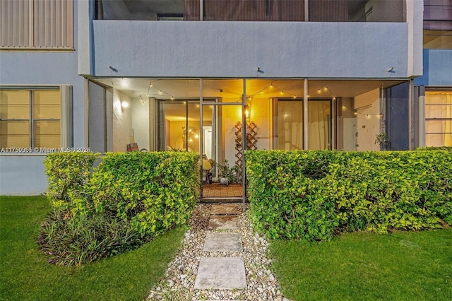 property entrance featuring stucco siding