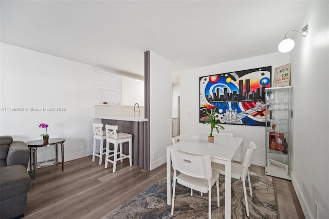 dining room featuring baseboards and wood finished floors