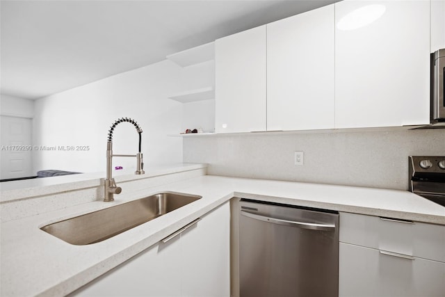kitchen featuring stainless steel dishwasher, a sink, open shelves, white cabinetry, and modern cabinets
