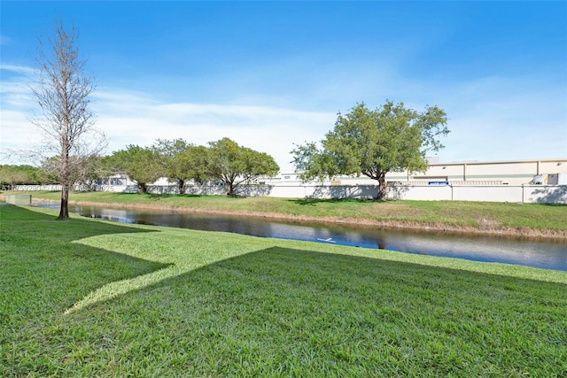 view of yard featuring a water view and fence