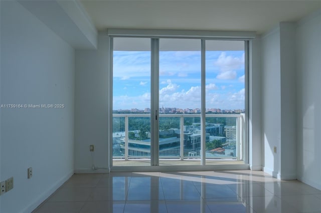 2889 Mcfarlane Rd Unit 1511, Miami, FL 33133 - tiled empty room with expansive windows, a city view, and baseboards