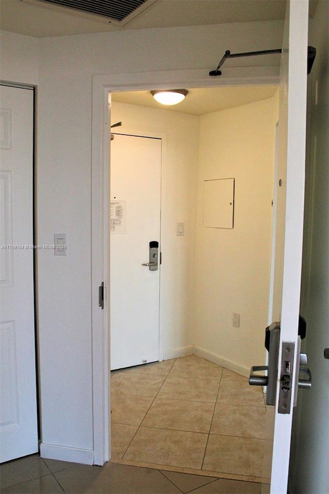 2889 Mcfarlane Rd Unit 1511, Miami, FL 33133 - corridor with light tile patterned flooring, visible vents, and baseboards