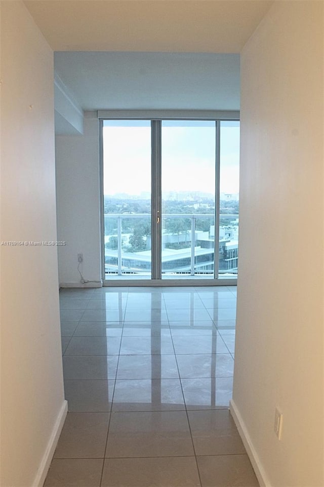2889 Mcfarlane Rd Unit 1511, Miami, FL 33133 - spare room with plenty of natural light, baseboards, and tile patterned floors
