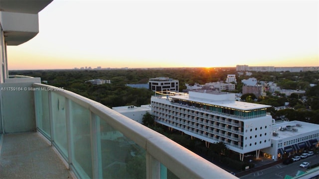 2889 Mcfarlane Rd Unit 1511, Miami, FL 33133 - balcony at dusk featuring a view of city