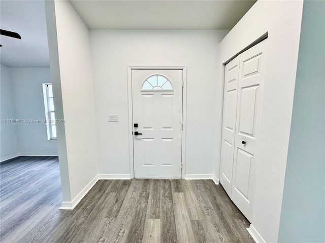 entrance foyer featuring baseboards and wood finished floors