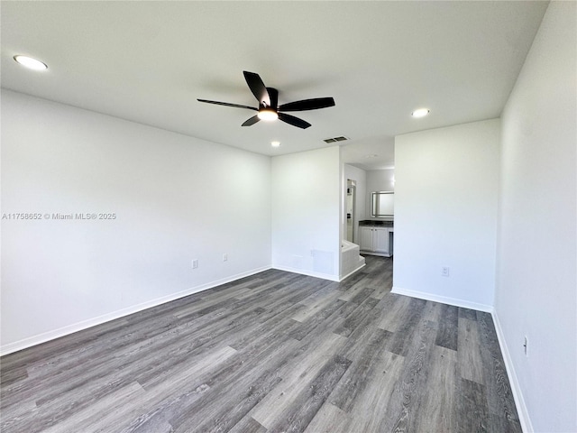 unfurnished room featuring dark wood-style flooring, recessed lighting, visible vents, ceiling fan, and baseboards