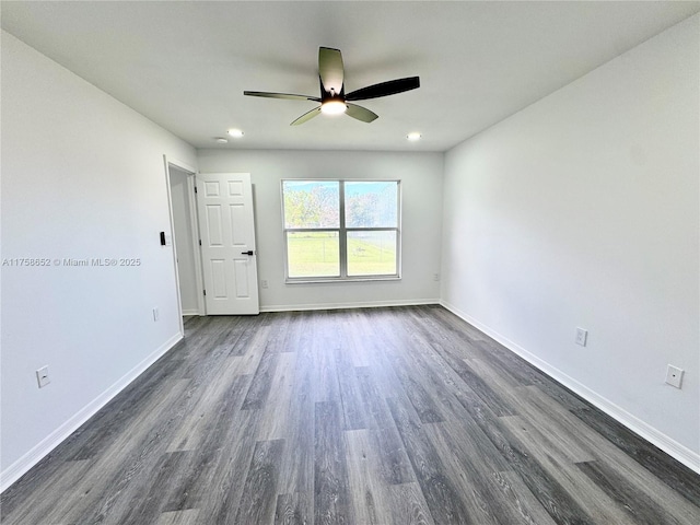 spare room with baseboards, dark wood finished floors, a ceiling fan, and recessed lighting