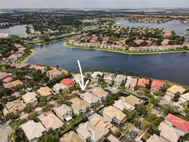 drone / aerial view with a residential view and a water view