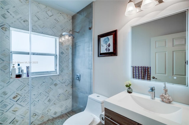 full bathroom with vanity, a shower stall, and toilet