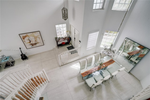 living room with a high ceiling and tile patterned floors