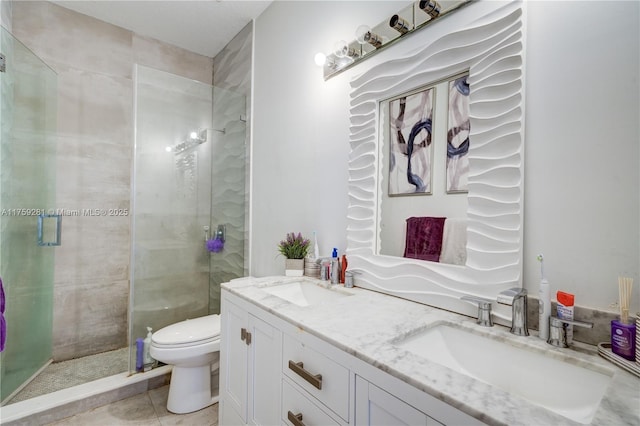 full bath with toilet, a stall shower, double vanity, and a sink