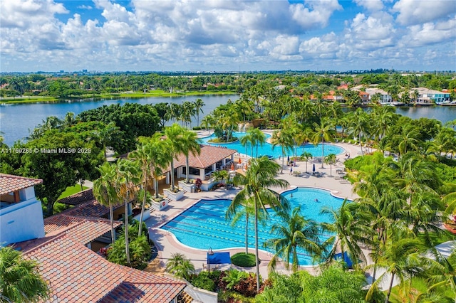 community pool with a patio and a water view