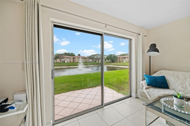 doorway to outside featuring a water view and light tile patterned flooring