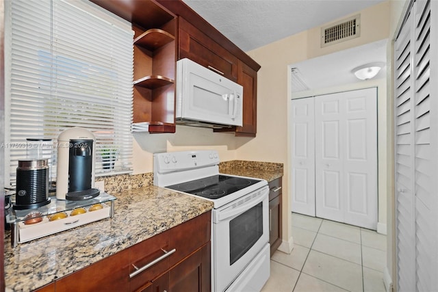 kitchen with light tile patterned floors, open shelves, visible vents, a textured ceiling, and white appliances