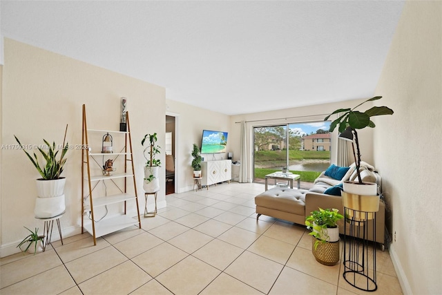 tiled living room featuring baseboards