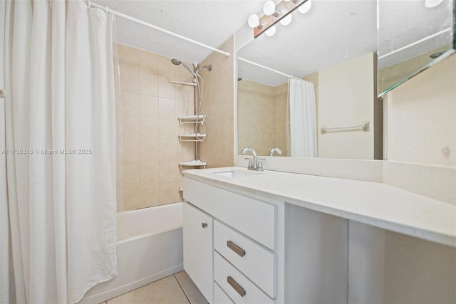 full bathroom with vanity, shower / bath combo with shower curtain, a textured ceiling, and tile patterned floors