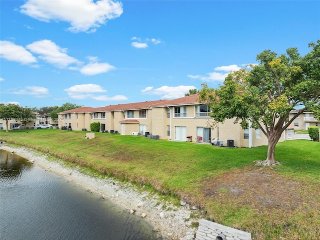 view of front of property with central AC unit, a front yard, and a residential view