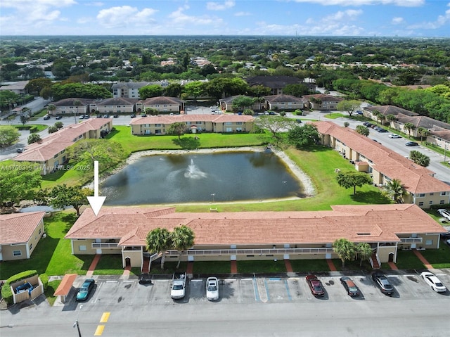 birds eye view of property with a water view and a residential view