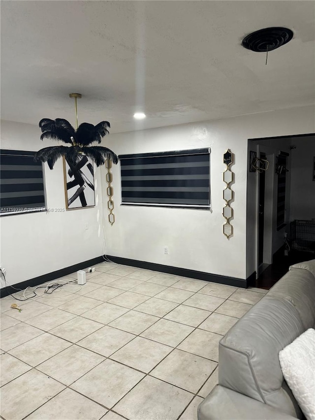 interior space featuring light tile patterned floors and baseboards