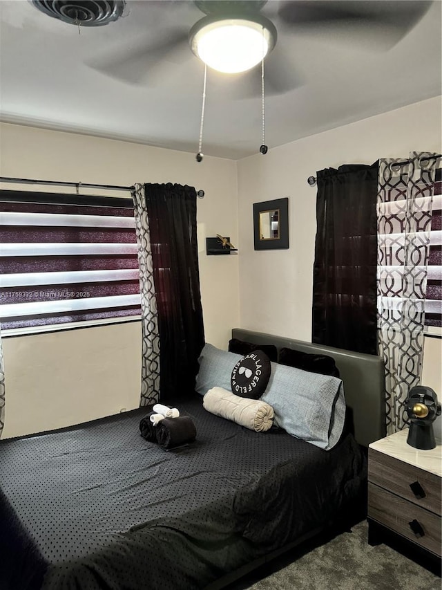 bedroom with a ceiling fan and carpet floors