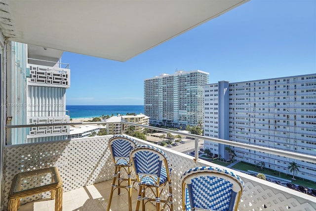 balcony featuring a city view and a water view