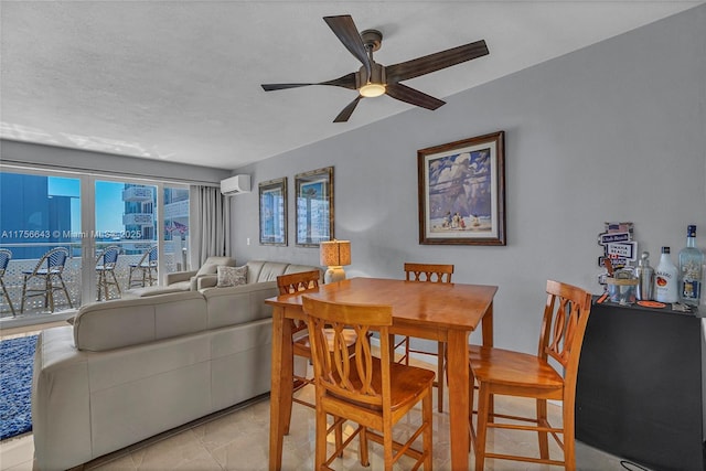 dining area with a textured ceiling, a wall mounted air conditioner, and ceiling fan