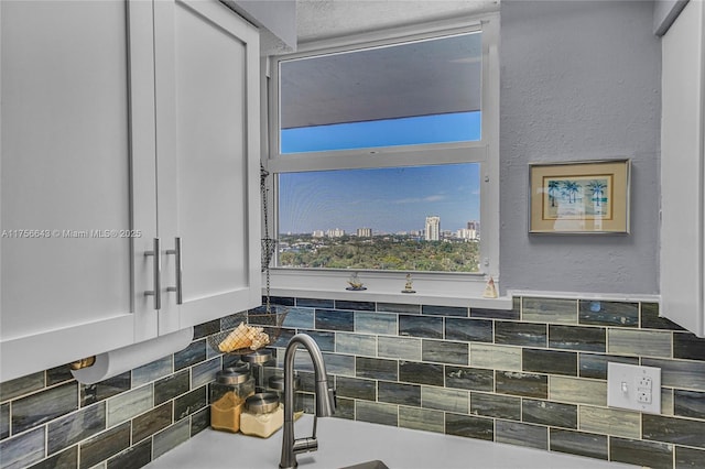 bathroom featuring a view of city and a textured wall