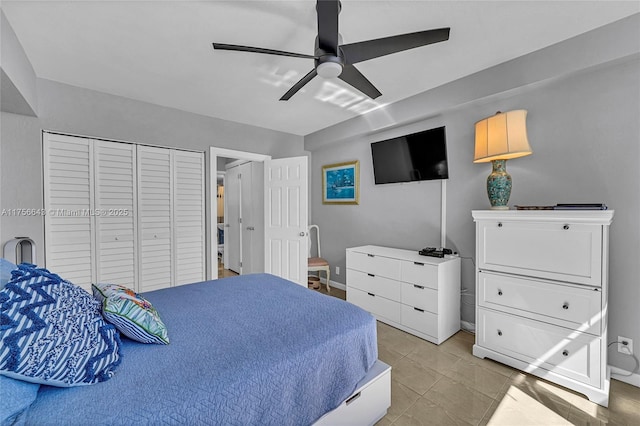 bedroom featuring a closet, light tile patterned floors, and ceiling fan