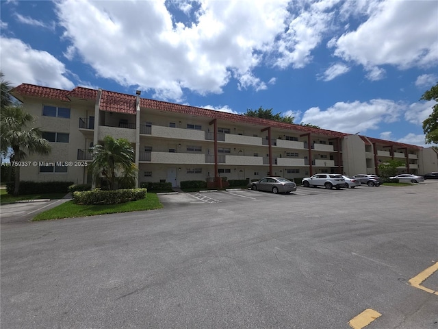 8940 S Hollybrook Blvd Unit 109, Pembroke Pines, FL 33025 - view of building exterior with uncovered parking