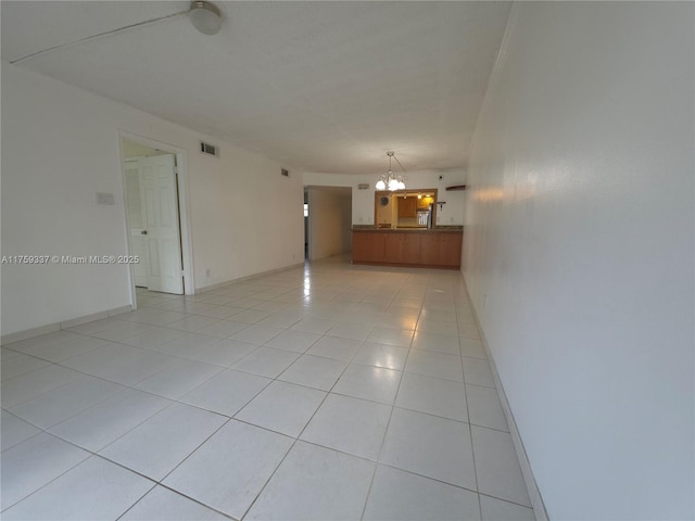 8940 S Hollybrook Blvd Unit 109, Pembroke Pines, FL 33025 - unfurnished room with light tile patterned floors, visible vents, and a notable chandelier